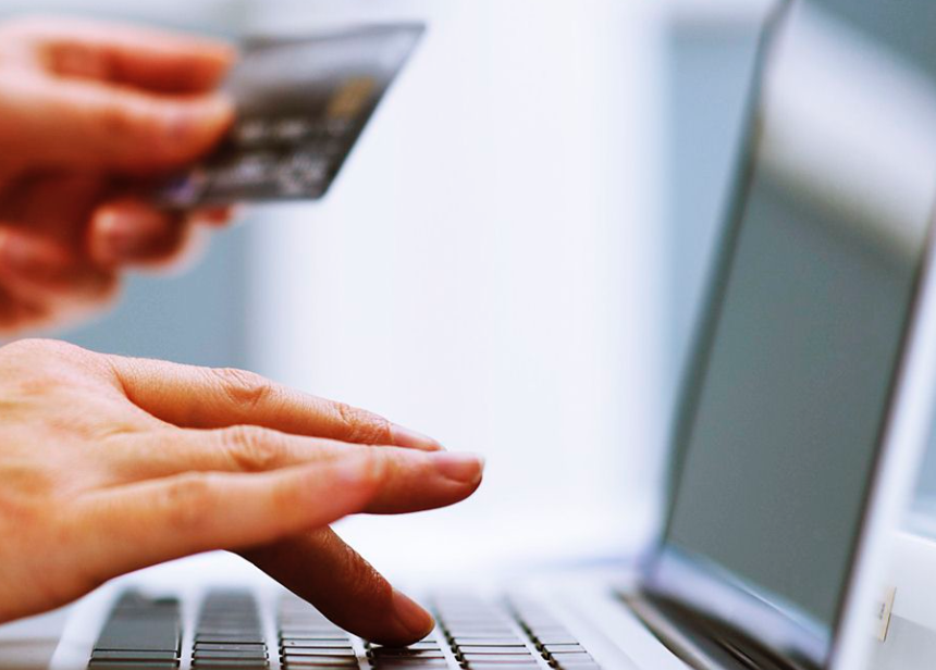 image of person making purchase with card on computer