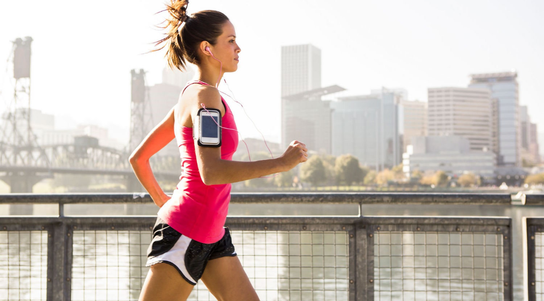 image of woman running and listening to music